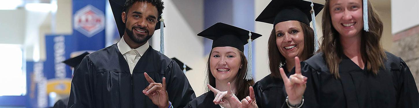 students posing for a photo at commencement